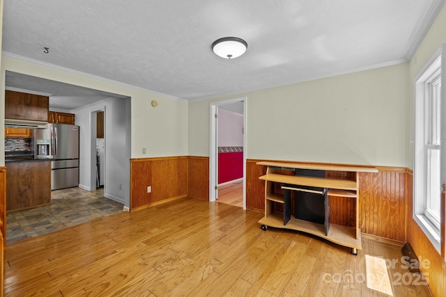 7011 S Providence Rd, Waxhaw, NC 28173 - unfurnished living room with wainscoting, wood finished floors, crown molding, wood walls, and a textured ceiling