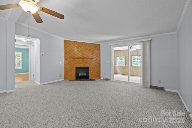 7011 S Providence Rd, Waxhaw, NC 28173 - unfurnished living room with carpet floors, healthy amount of natural light, crown molding, a fireplace, and a ceiling fan