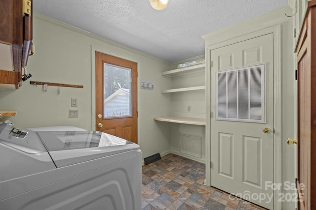 7011 S Providence Rd, Waxhaw, NC 28173 - laundry room with separate washer and dryer, stone finish floors, a textured ceiling, ornamental molding, and cabinet space
