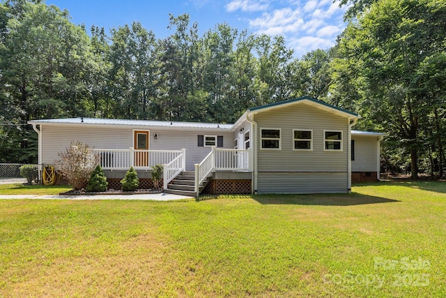 7011 S Providence Rd, Waxhaw, NC 28173 - manufactured / mobile home featuring a deck, a front lawn, and a metal roof