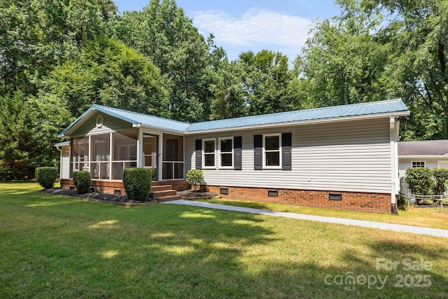 7011 S Providence Rd, Waxhaw, NC 28173 - view of front of home featuring crawl space, a sunroom, a front lawn, and a metal roof