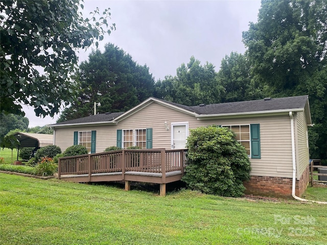 117 Haystack Ln, Olin, NC 28660 - back of house featuring a wooden deck, a detached carport, and a yard