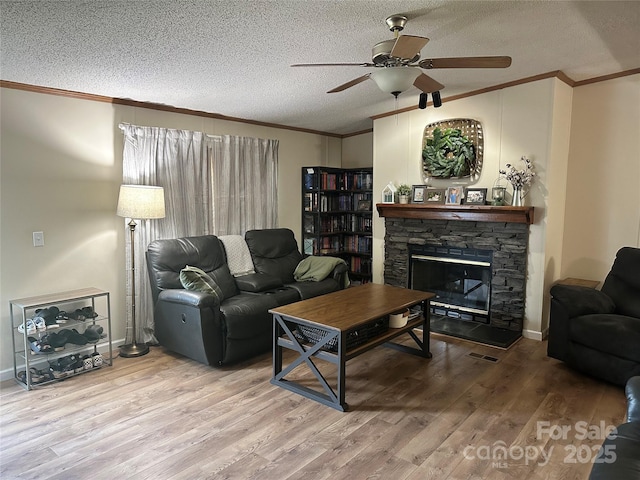 117 Haystack Ln, Olin, NC 28660 - living area with a fireplace, ornamental molding, wood finished floors, a ceiling fan, and a textured ceiling