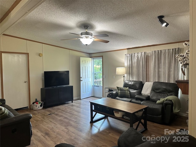 117 Haystack Ln, Olin, NC 28660 - living room with crown molding, ceiling fan, a textured ceiling, and wood finished floors