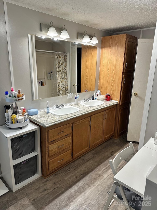 117 Haystack Ln, Olin, NC 28660 - full bathroom featuring wood finished floors, double vanity, a textured ceiling, and a shower with shower curtain