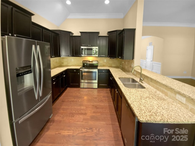 13419 Morgan Lee Ave, Charlotte, NC 28213 - kitchen featuring stainless steel appliances, a peninsula, light stone counters, tasteful backsplash, and crown molding