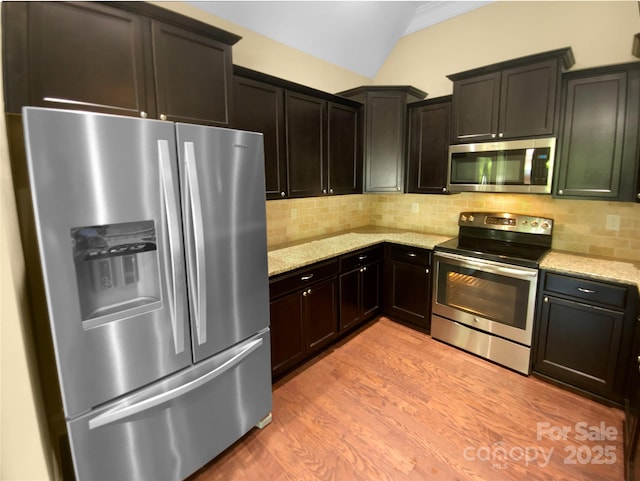 13419 Morgan Lee Ave, Charlotte, NC 28213 - kitchen with appliances with stainless steel finishes, light stone counters, light wood finished floors, backsplash, and vaulted ceiling