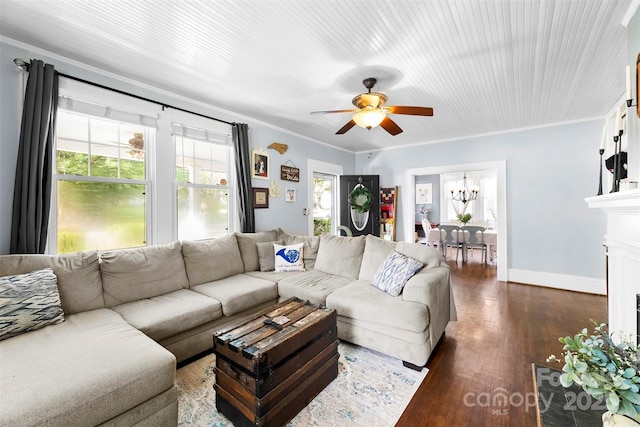 1210 Jackson Rd, Gastonia, NC 28052 - living room featuring a ceiling fan, crown molding, dark wood-type flooring, a fireplace with flush hearth, and a chandelier
