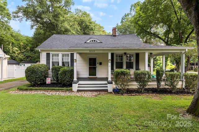 1210 Jackson Rd, Gastonia, NC 28052 - view of front of house with covered porch, a chimney, a front lawn, and roof with shingles