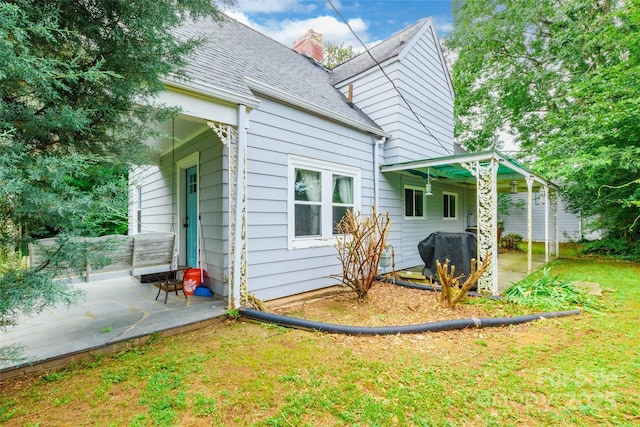 904 Venus St, Kannapolis, NC 28083 - back of house featuring a patio, a shingled roof, a lawn, and a chimney
