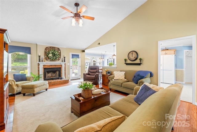 4313 Wynborough Ln, Charlotte, NC 28269 - living area with wood finished floors, healthy amount of natural light, ceiling fan, high vaulted ceiling, and a brick fireplace