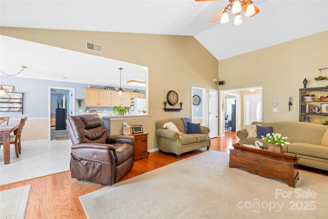 4313 Wynborough Ln, Charlotte, NC 28269 - living room with high vaulted ceiling, a ceiling fan, and light wood-style floors