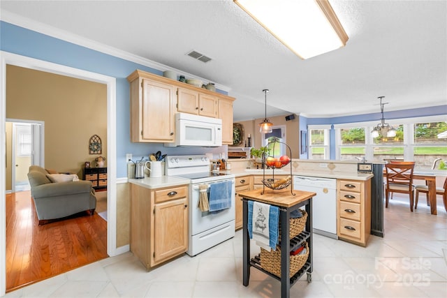 4313 Wynborough Ln, Charlotte, NC 28269 - kitchen featuring white appliances, a peninsula, light brown cabinetry, light countertops, and hanging light fixtures
