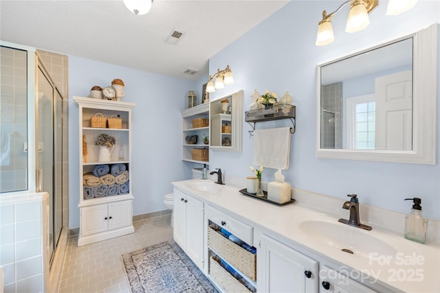 4313 Wynborough Ln, Charlotte, NC 28269 - bathroom with double vanity, a stall shower, and tile patterned floors