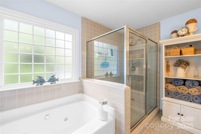 4313 Wynborough Ln, Charlotte, NC 28269 - bathroom with a tub with jets, a stall shower, and tile patterned flooring