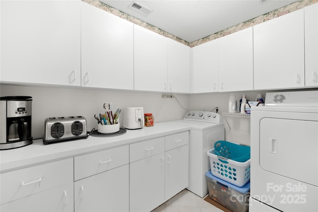 4313 Wynborough Ln, Charlotte, NC 28269 - laundry room featuring cabinet space, washer and dryer, and a textured ceiling