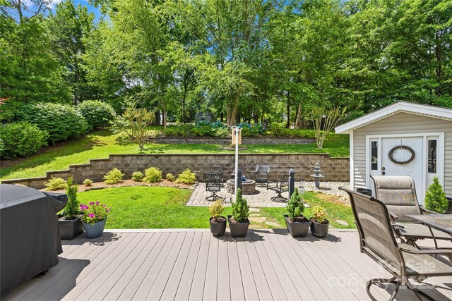 4313 Wynborough Ln, Charlotte, NC 28269 - wooden deck featuring a yard, an outbuilding, view of wooded area, and area for grilling