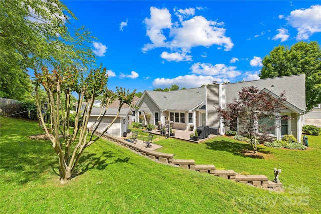 4313 Wynborough Ln, Charlotte, NC 28269 - back of property featuring a lawn, a chimney, an outdoor structure, and a wooden deck