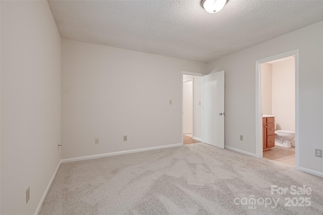 1801 Teddington Dr, Charlotte, NC 28214 - unfurnished bedroom with a textured ceiling, light carpet, and ensuite bath