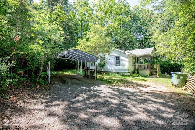 47 Campground Rd, Asheville, NC 28805 - view of home's exterior with a detached carport, a deck, and dirt driveway