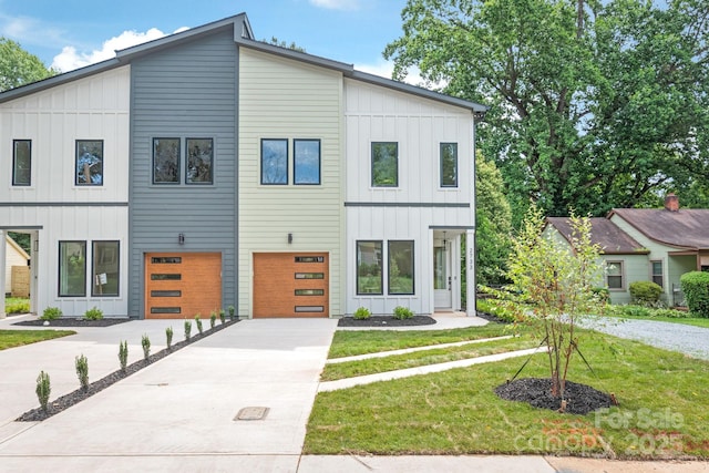 2733 Cowles Rd, Charlotte, NC 28208 - view of front of home with board and batten siding, driveway, an attached garage, and a front lawn