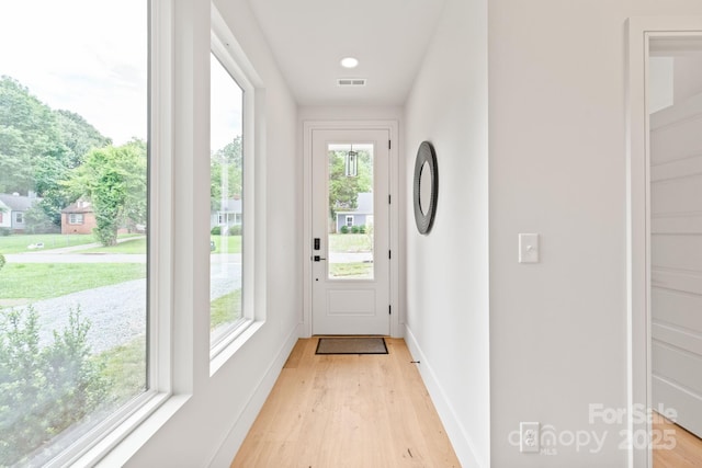 2733 Cowles Rd, Charlotte, NC 28208 - doorway to outside featuring light wood finished floors and baseboards