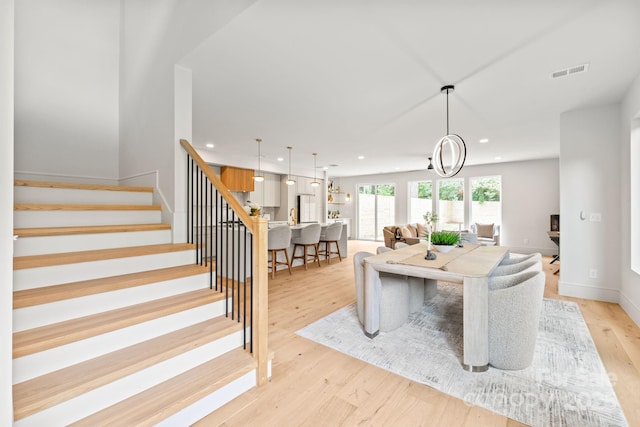 2733 Cowles Rd, Charlotte, NC 28208 - dining room with stairs, light wood-type flooring, and recessed lighting