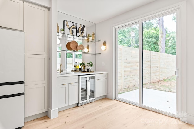 2733 Cowles Rd, Charlotte, NC 28208 - indoor wet bar with beverage cooler, plenty of natural light, and light wood-style floors