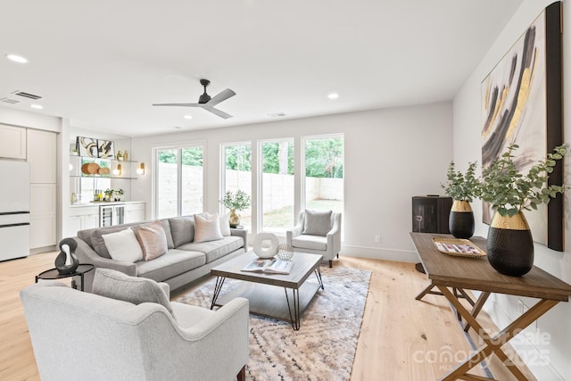 2733 Cowles Rd, Charlotte, NC 28208 - living area with wine cooler, healthy amount of natural light, a bar, light wood finished floors, and recessed lighting