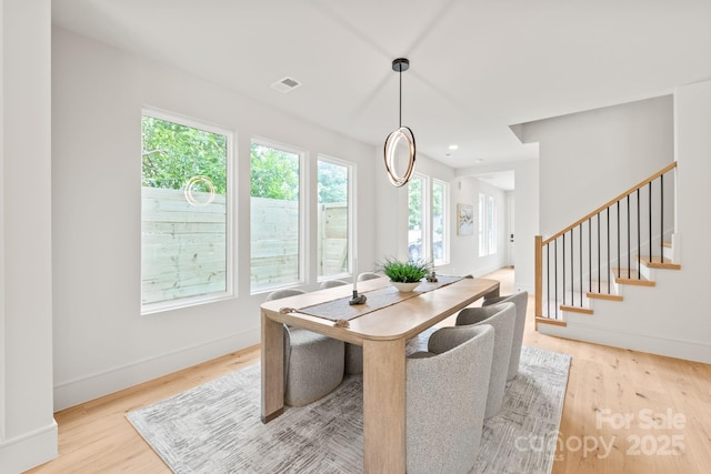 2733 Cowles Rd, Charlotte, NC 28208 - dining room with light wood finished floors and stairway