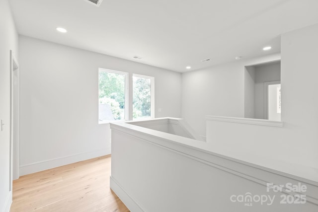 2733 Cowles Rd, Charlotte, NC 28208 - corridor with light wood finished floors, recessed lighting, and an upstairs landing