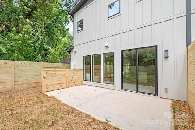 2733 Cowles Rd, Charlotte, NC 28208 - back of property featuring board and batten siding and a patio area