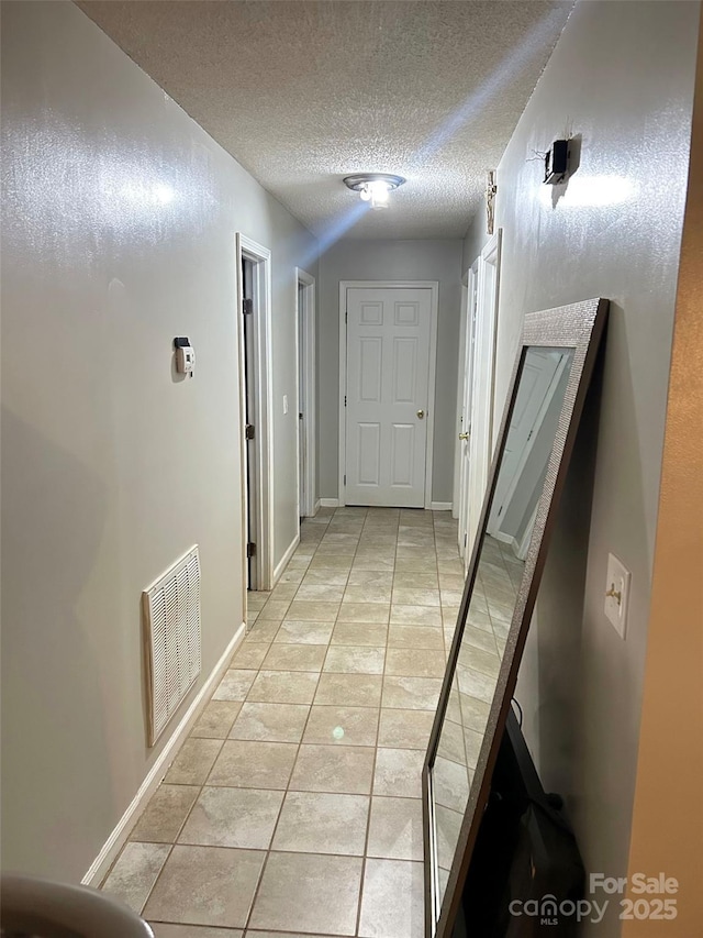 1250 Landsdowne Dr, Conover, NC 28613 - hall featuring light tile patterned floors and a textured ceiling