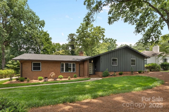 3701 Table Rock Rd, Charlotte, NC 28226 - view of front of home featuring board and batten siding, brick siding, a front lawn, and a chimney