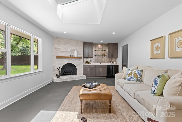 3701 Table Rock Rd, Charlotte, NC 28226 - living room featuring concrete flooring, recessed lighting, wine cooler, and a tile fireplace