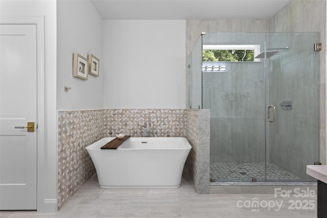 3701 Table Rock Rd, Charlotte, NC 28226 - full bath featuring a freestanding bath, a stall shower, tile walls, and wainscoting