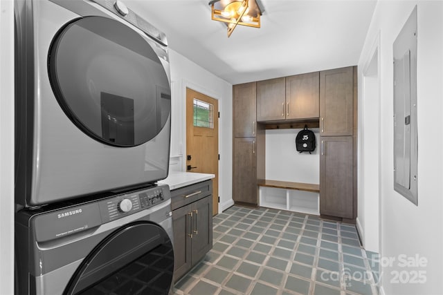 3701 Table Rock Rd, Charlotte, NC 28226 - washroom with stacked washing machine and dryer, tile patterned floors, cabinet space, and electric panel