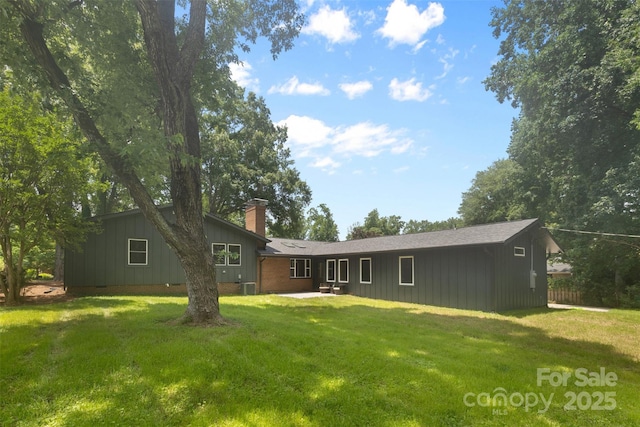 3701 Table Rock Rd, Charlotte, NC 28226 - back of property featuring a chimney, a patio area, a yard, and board and batten siding