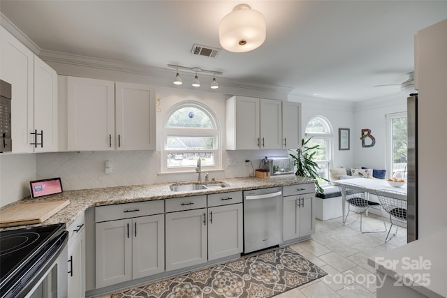 11615 Chadburn Ln, Charlotte, NC 28215 - kitchen featuring stainless steel appliances, backsplash, ornamental molding, white cabinetry, and a ceiling fan