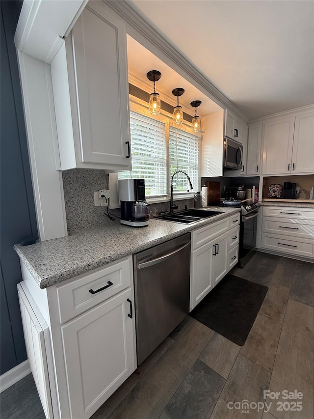 1314 Hathcock Ave, Albemarle, NC 28001 - kitchen featuring appliances with stainless steel finishes, dark wood finished floors, white cabinetry, and decorative backsplash