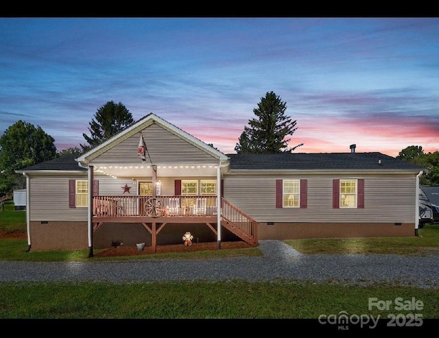 32 Bishop Ln, Flat Rock, NC 28731 - back of house at dusk featuring crawl space