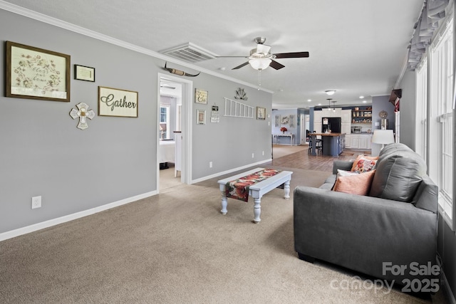 32 Bishop Ln, Flat Rock, NC 28731 - carpeted living room featuring crown molding, a ceiling fan, and plenty of natural light