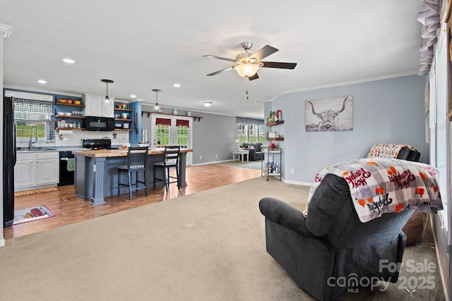 32 Bishop Ln, Flat Rock, NC 28731 - living room with ornamental molding, a ceiling fan, light carpet, recessed lighting, and light wood-type flooring