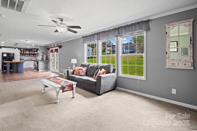 32 Bishop Ln, Flat Rock, NC 28731 - carpeted living room featuring ornamental molding, a dry bar, and a ceiling fan