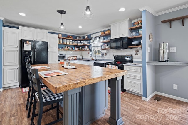 32 Bishop Ln, Flat Rock, NC 28731 - kitchen with open shelves, black appliances, crown molding, decorative backsplash, and recessed lighting