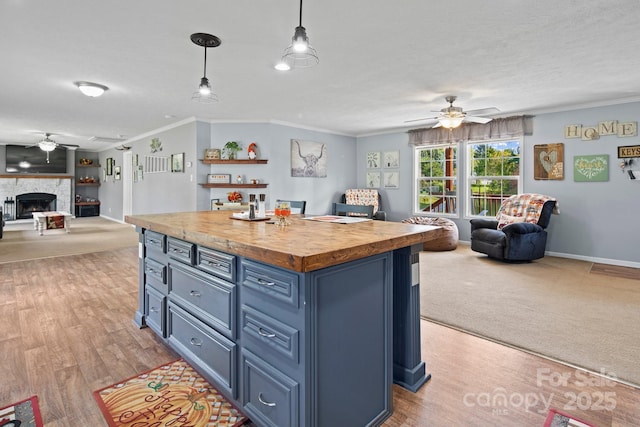 32 Bishop Ln, Flat Rock, NC 28731 - kitchen featuring open floor plan, a ceiling fan, wood counters, blue cabinetry, and crown molding