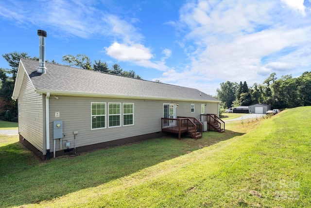 32 Bishop Ln, Flat Rock, NC 28731 - back of house featuring a deck, a yard, roof with shingles, and an outbuilding