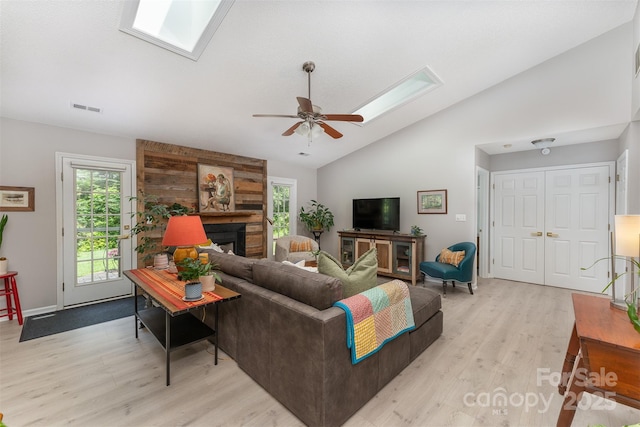 330 Stonehollow Rd, Fletcher, NC 28732 - living room with a skylight, lofted ceiling, light wood-type flooring, a ceiling fan, and a large fireplace