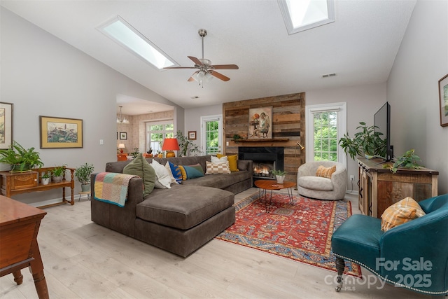 330 Stonehollow Rd, Fletcher, NC 28732 - living area featuring a skylight, light wood-type flooring, a large fireplace, a ceiling fan, and high vaulted ceiling
