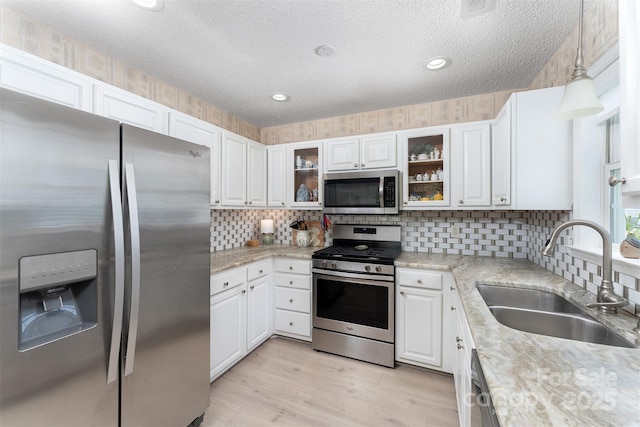 330 Stonehollow Rd, Fletcher, NC 28732 - kitchen with appliances with stainless steel finishes, a textured ceiling, backsplash, white cabinets, and recessed lighting